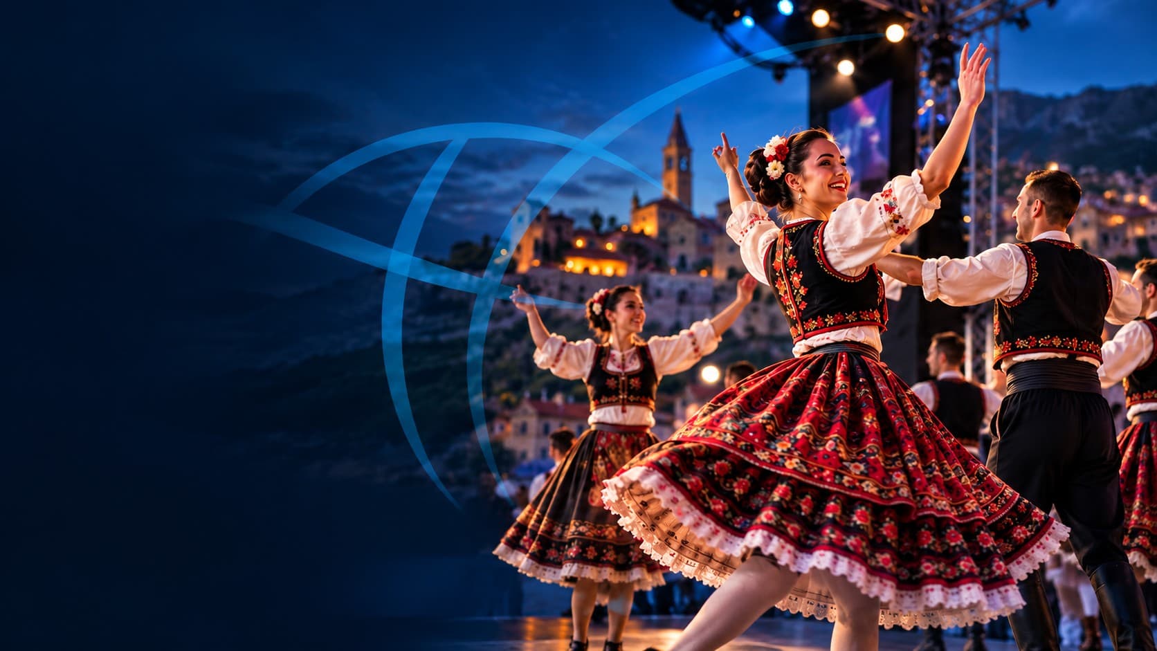 Folk dancers in embroidered costumes performing on an open-air festival stage at dusk